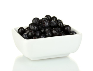 ripe blueberries in white bowl isolated on white