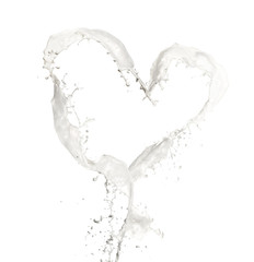 Heart symbol made of milk splashes, isolated on white background