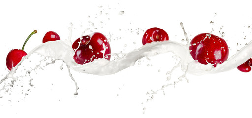 Cherries in cream splash, isolated on white background