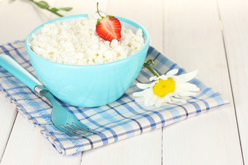 cottage cheese with strawberry in blue bowl and fork