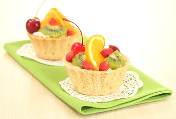 sweet cake with fruits on wooden table