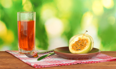 Green passion fruit in the plate on bright green background
