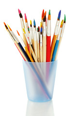 Paint brushes with gouache in cup isolated on white