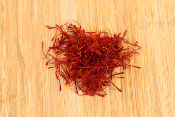 Fototapeta premium stigmas of saffron on wooden background close-up