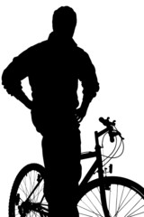 A silhouette of a  young boy posing on a bike