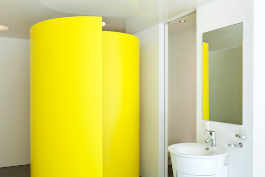 Bathroom with a colored shower cubicle in hotel