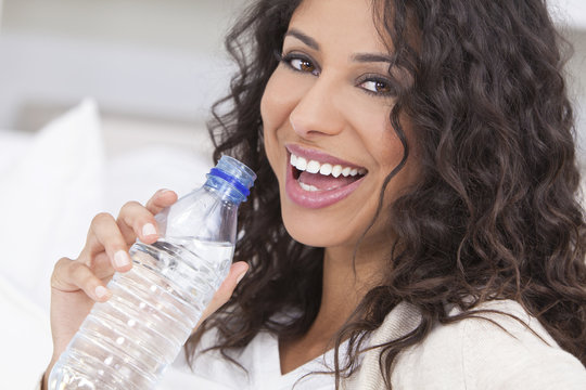 Happy Hispanic Woman Drinking Bottle Of Water