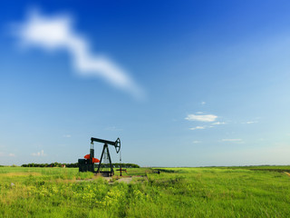 A pumpjack by a grassy