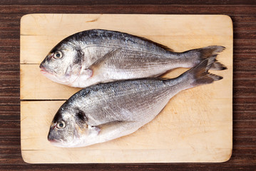 Sea bream on cutting board.