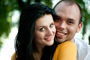 Naklejka premium Closeup portrait of smiling young couple in love - Outdoors