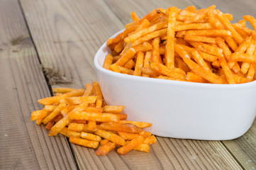 Potato Sticks in a bowl on wood