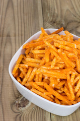 Potato Sticks in a bowl on wood