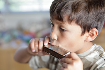 Boy playing with harmonica