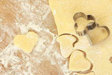 tins of cookies on the rolled out dough close-up