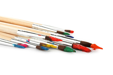 Fototapeta premium Paint brushes with gouache isolated on white