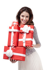 Pretty woman hands many presents wrapped in red paper