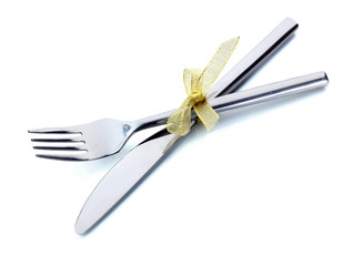 Silver fork and knife tied with ribbon isolated on white