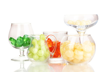 Color candies in glasses isolated on white