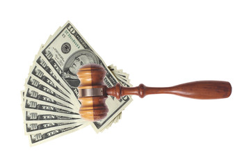 Many dollars and judge's gavel isolated on white