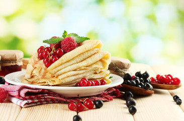 pancakes with berries, jam and honey