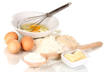 Eggs, flour and butter isolated on white