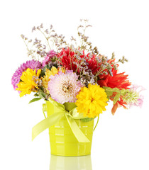 Bright green bucket with flowers isolated on white