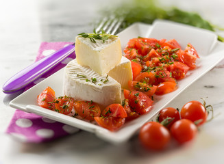 tomino cheese with pachino tomatoes salad,selective focus
