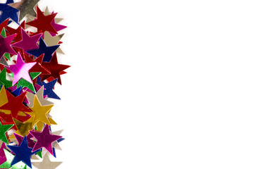 Christmas decoration of colored confetti stars against white bac