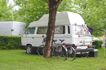 camper and bicycles on a camping site