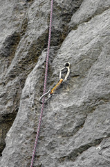 Carbine and hook with rope in stone