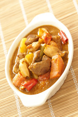 Delicious pork curry with squid on bamboo mat