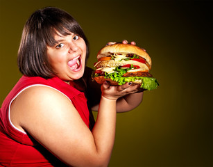 Woman eating hamburger.