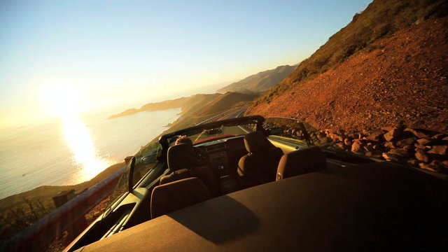 Open Top Cabriolet Driving Winding Coastal Road