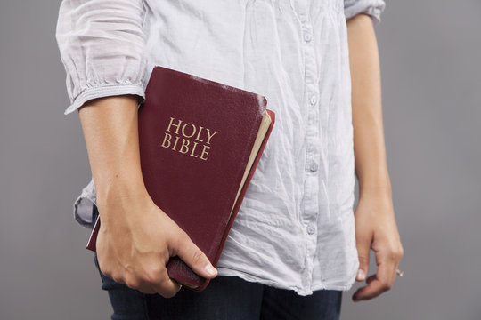 Woman Holds Bible On Her Side
