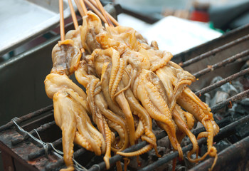 Thai style squid on a stick on the grill