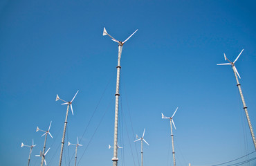 Wind turbine on blue sky background