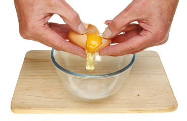 Hands cracking egg