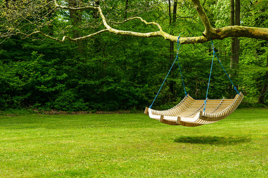 Swing bench in lush garden