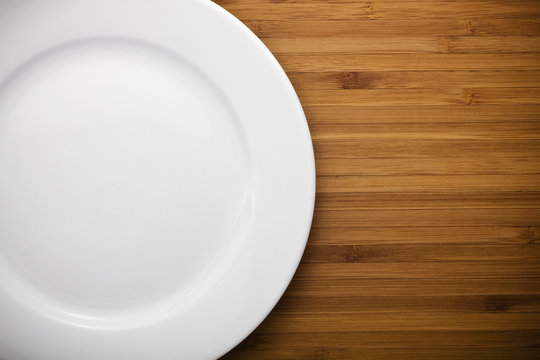 single white plate on old wood background
