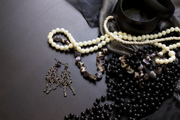 Jewels and the earrings on a wooden table
