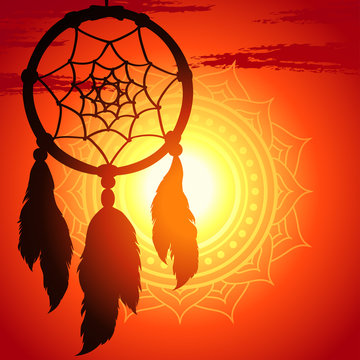 dream catcher, silhouette of a feather on a background sunset