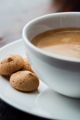 Cup of cafe crema with biscotti