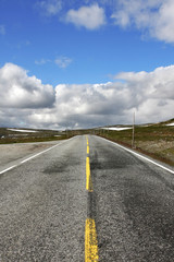 Asphalt road through the Hardangervidda plateau, Norway