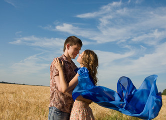 Loving couple on wheat field