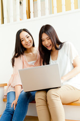 Beautiful young business women using a laptop. Portrait of asian