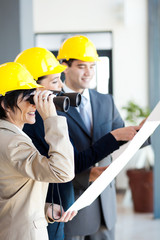 architect looking at construction site with binoculars