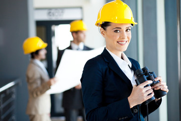 female construction manager with binoculars