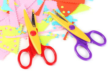 Colorful zigzag scissors with color paper isolated on white