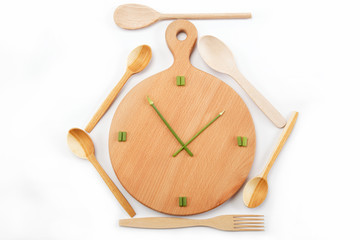 Lunch time. Meals. Watches are made of green onions on a wooden