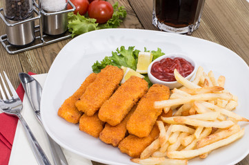 Portion of Fish Fingers on wooden background